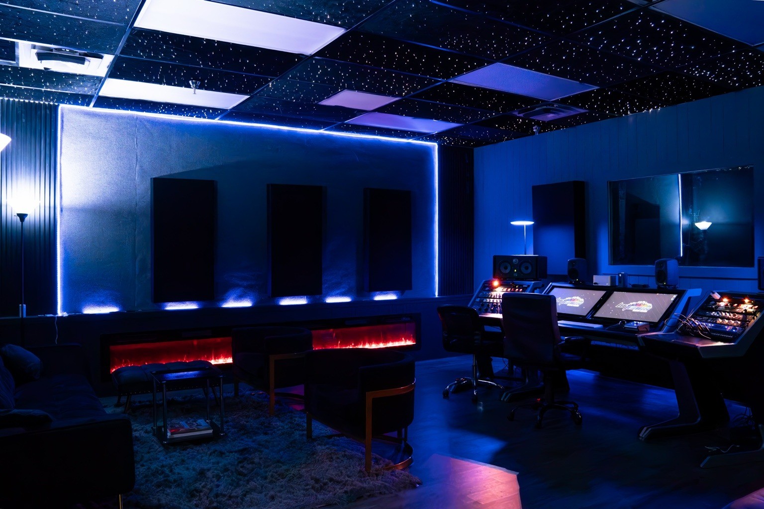 Wide establishing view of the Hi-Tunes Studio Premium Room, showing the star-ceiling treatment, workstation, seating, and acoustic treatment.